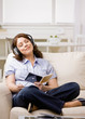 Relaxed woman in headphones enjoying listening to music