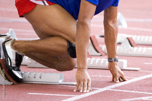 Photo: Image of a 100 meters athlete at the starting block. Image of a 100 meters athlete at the starting block.