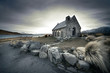Small church in New Zealand with lake and mountains