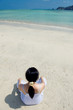 young woman meditating on the beach