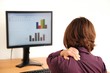 Business woman with neck pain sitting at computer Business woman with neck pain sitting at computer