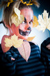 Jack-o-lantern girl with leaves isolated in studio