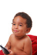 A multi-racial baby boy wrapped in a red blanket