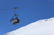 Chair lift with skiers at ski resort. Winter holidays
