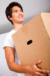 man moving homes smiling and carrying a carton box