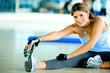 beautiful woman at the gym doing stretching exercise