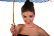 Beautiful Young Woman under a Blue Umbrella