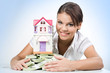 Portrait of beautiful woman touching heap of money