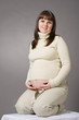 happy pregnant woman portrait on gray background