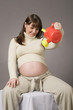 happy pregnant woman portrait with watering can in hands