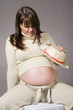 happy pregnant woman portrait on gray background