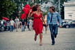 Runnng happy teenage couple in street