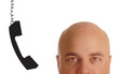 head of bald man with phone receiver dangling