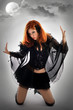 Portrait of a young beautiful witch in the black dress