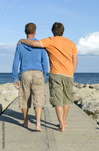 Photo: Gay couple walking on pathway Gay couple walking on pathway