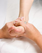 Female hands giving a healthy foot massage