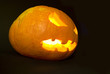 Evil Pumpkin head with light inside in complete darkness