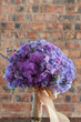 A colorful purple bridal bouquet of flowers