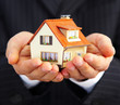 Hand of the businessman with the house...