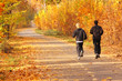 Two young boys run in the park.