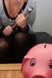 Piggy bank, woman holding hammer,  money trouble