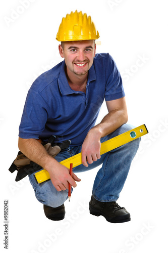 Photo: young friendly crouch manual worker isolated on white young friendly crouch manual worker isolated on white