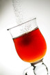 freshly brewed cup of tea with falling sugar granules