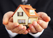Hand of the businessman with the house...