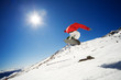 Snowboarder jumping with blue sky in background