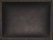 A dark leather frame with surrounding stitches