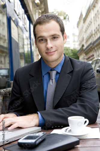Photo: A handsome business man in an outdoors cafe A handsome business man in an outdoors cafe