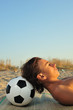 Young boy sunbuthing on beach, close up