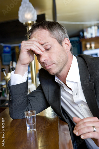 Photo: A depressed man with a shot of vodka A depressed man with a shot of vodka