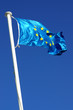 Photo: Flag of the european union over a deep blue sky Flag of the european union over a deep blue sky