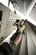 Photographer in New York City. Wide angle view from below.