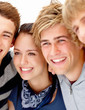Happy young teens checking out something