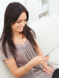 Young woman sitting at home listening to music mp3 player
