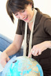 Woman going on vacation  leave Globe Earth.