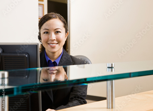 Telephone Earpiece on Photo  Receptionist With Telephone Earpiece Working At Desk In Office