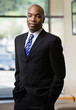 Photo: Confident African businessman posing in full suit Confident African businessman posing in full suit