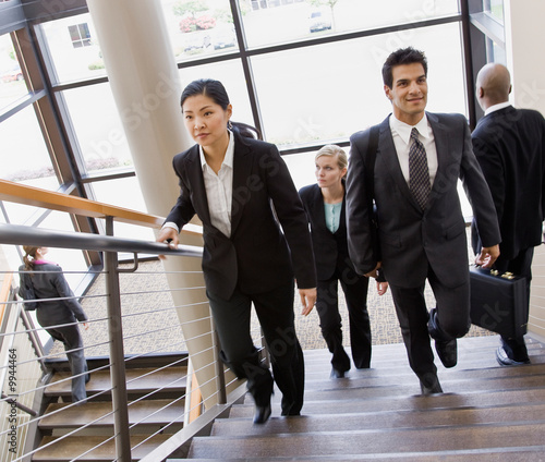 Photo: Co-workers ascending and descending office stairs Co-workers ascending and descending office stairs