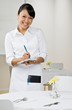 Happy waitress writing lunch order in elegant restaurant