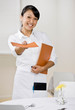 Happy waitress offering menu in elegant restaurant