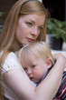 young mother holds and comforts a 17 month old baby