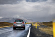 A new car driving fast on a road in a countryside