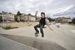 Boy practicing skate in a skate park - isolated