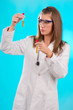 young female doctor looking at the chemical tubes, focus on tube