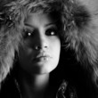 Fashion portrait of young pretty woman with fur