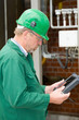 Middle aged industrial worker with notebook