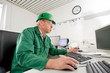 Industrial worker in his office in front of a pc
